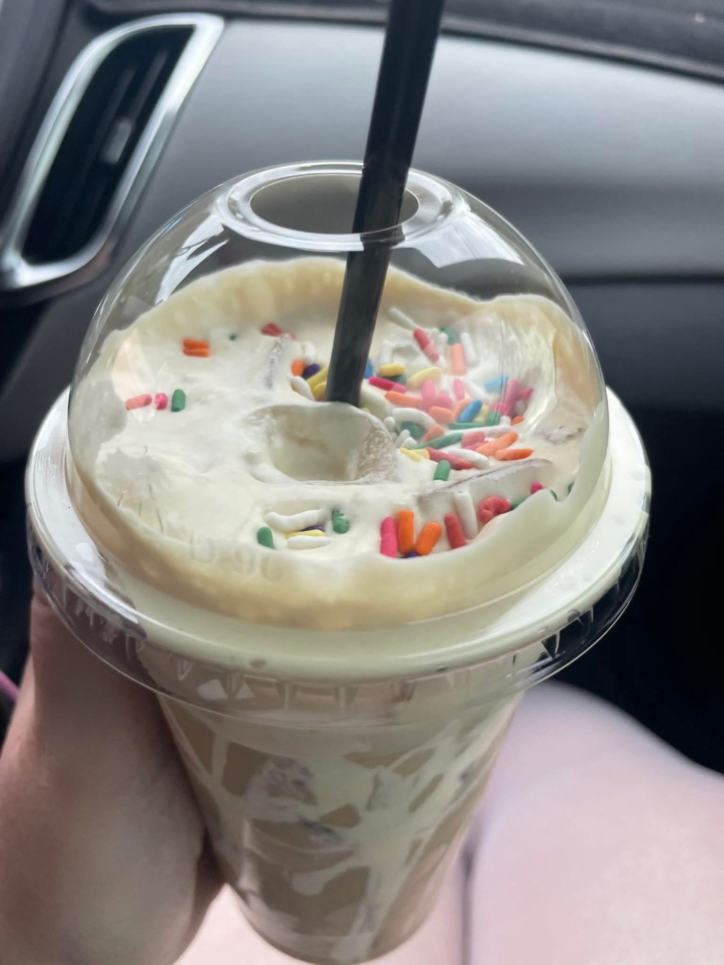 A cake-batter frozen brew topped with whipped cream and rainbow sprinkles.